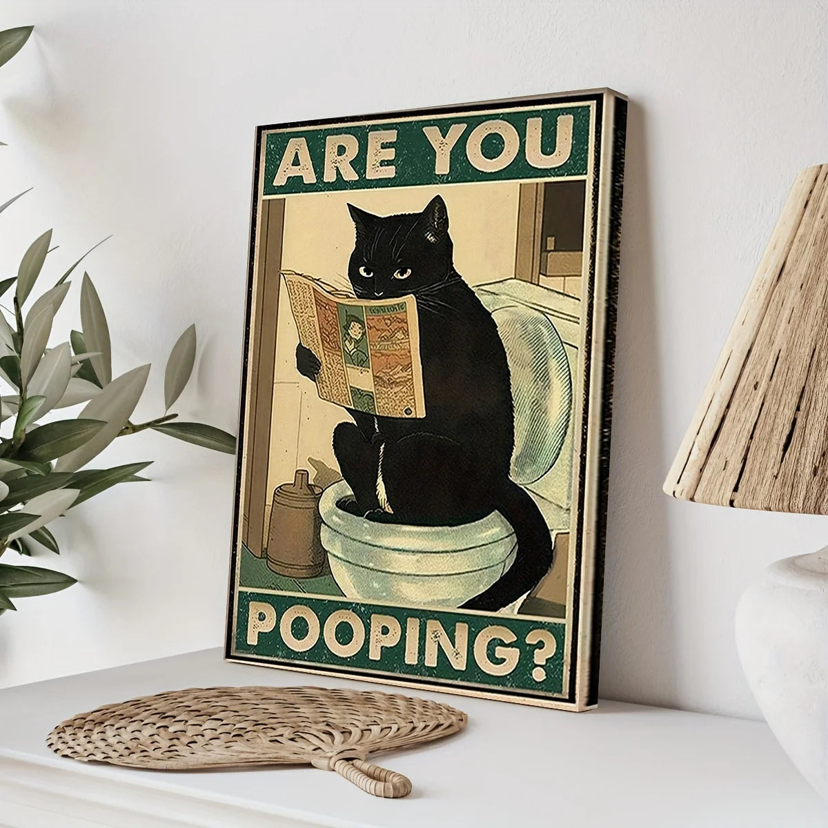 Retro wall art of kitten reading paper on toilet